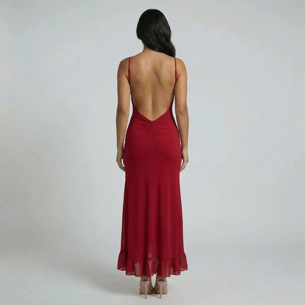 Red cutout maxi dress with open back and flowing flounce hem — back view.