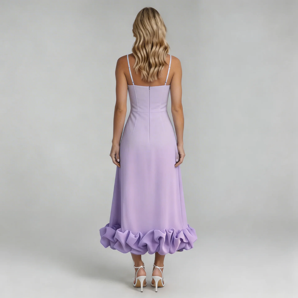 Back view of a woman in a light purple Hadley Ruffle Midi Dress, showcasing the fitted bodice and voluminous ruffled hem, worn with white heels.