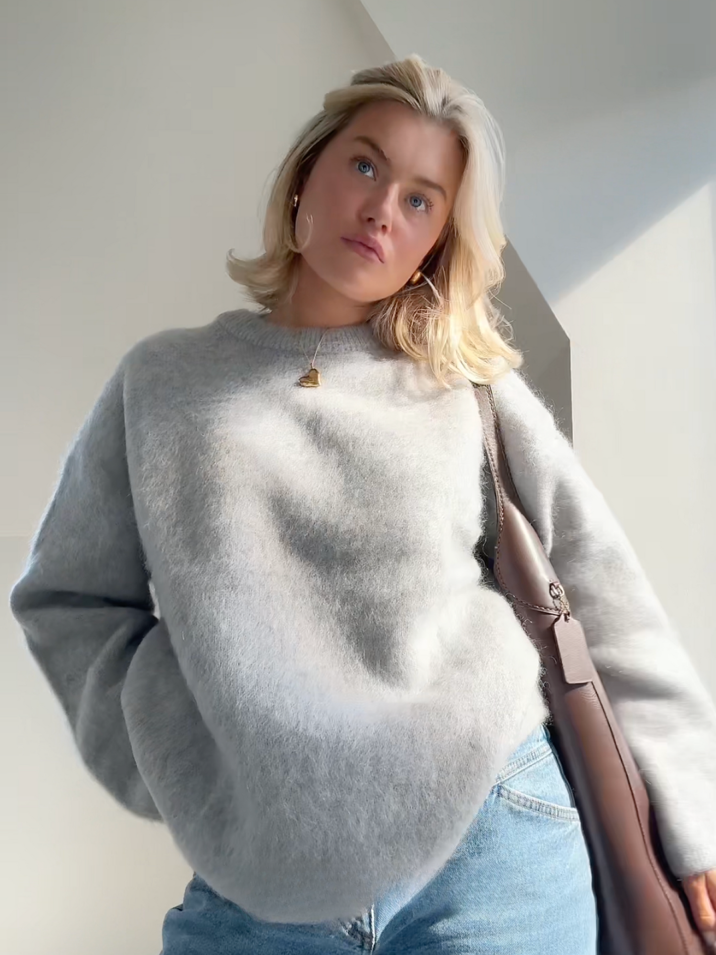 Women grey crew neck balloon sweater, back view