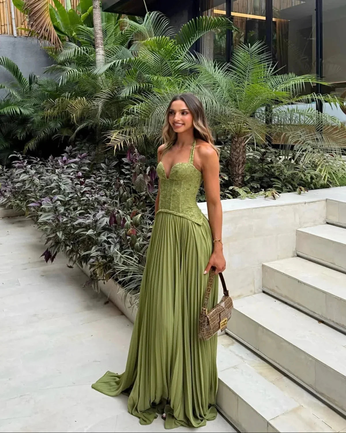 Women green lace corset maxi dress with sweetheart halter neckline and pleated floor length skirt