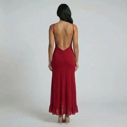 Red cutout maxi dress with open back and flowing flounce hem — back view.