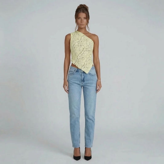 Cream floral lace asymmetric one-shoulder top with handkerchief hem — front view styled with blue jeans.