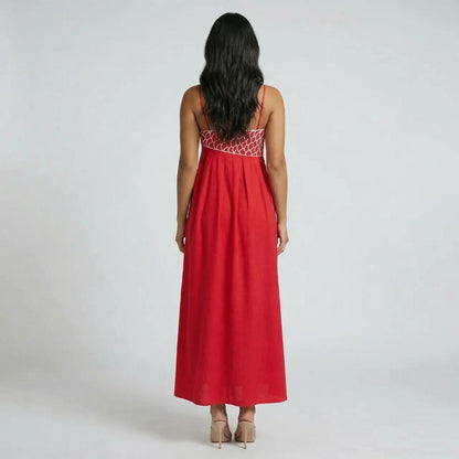 Rear view of red graphic maxi dress showing empire seam and flowy skirt.