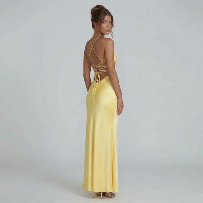 Yellow lace-up maxi dress — back view highlighting the strappy open-back lace-up detail for a dramatic effect.