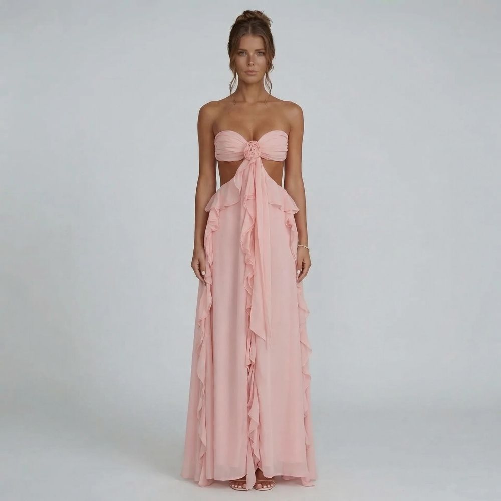 Strapless blush pink maxi dress with chiffon ruffles — front view showing rosette detail.