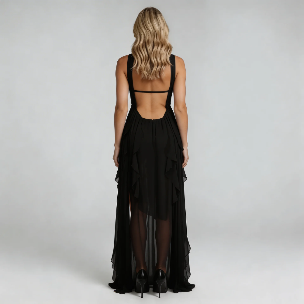 Black ruffle maxi dress — back view highlighting open-back detail and flowing fabric.
