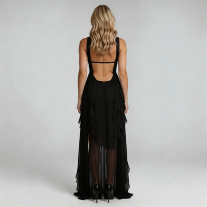Black ruffle maxi dress — back view highlighting open-back detail and flowing fabric.