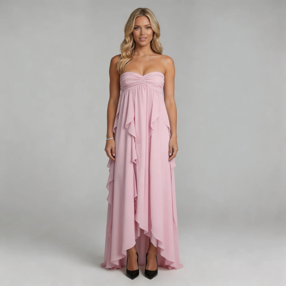 Pink ruffle maxi dress with sweetheart neckline — ethereal layered ruffles styled with pointed heels.