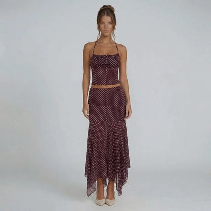 Burgundy polka dot high-waisted midi skirt — front view showcasing flowy handkerchief hem silhouette.