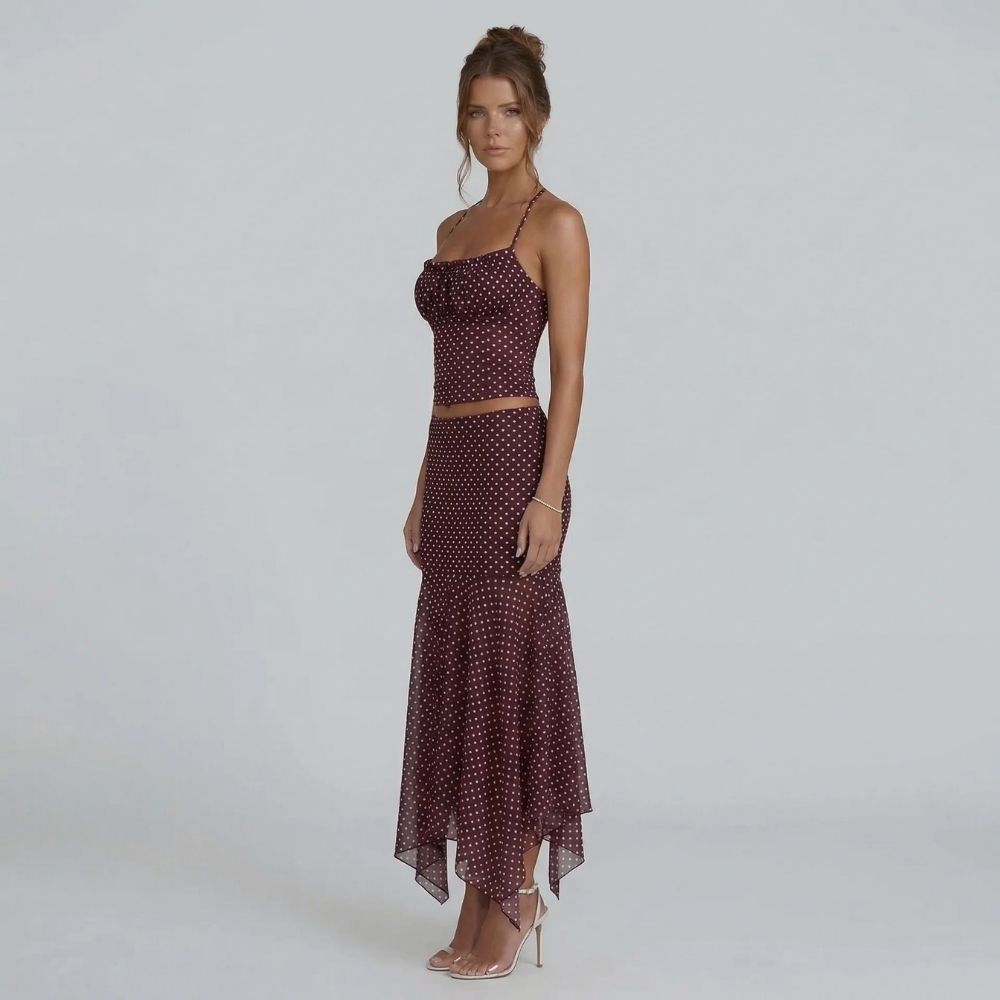 Burgundy polka dot ruched cami and midi skirt set — angled view with handkerchief hem detail.