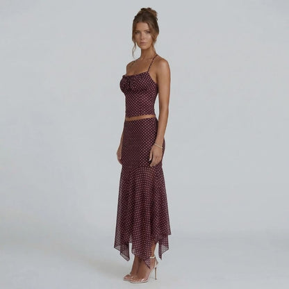 Burgundy polka dot ruched cami and midi skirt set — angled view with handkerchief hem detail.