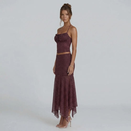 Burgundy polka dot ruched cami and midi skirt set — angled view with handkerchief hem detail.
