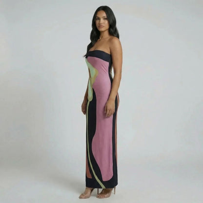 Side view of pink strapless abstract maxi dress — sleek column fit and maxi-length hem.