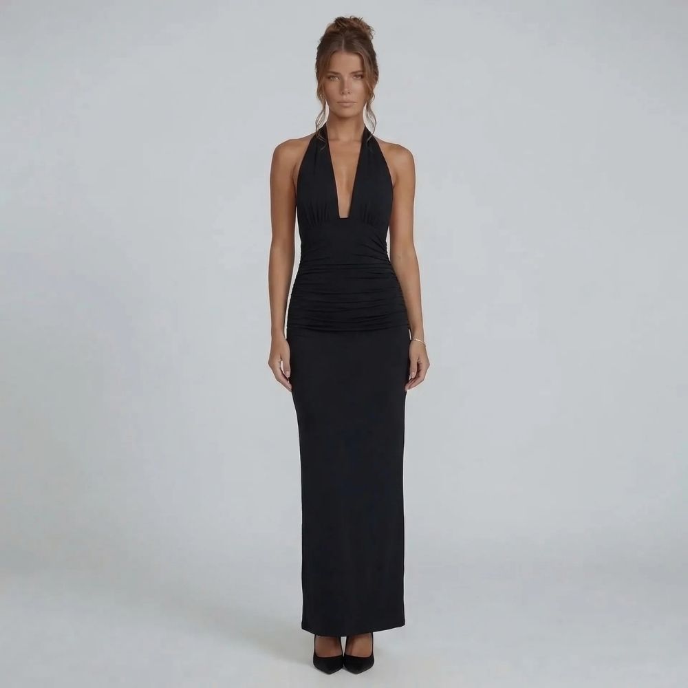 Black maxi dress with ruched waist and open back tie — back view emphasizing bold detail