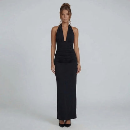 Black maxi dress with ruched waist and open back tie — back view emphasizing bold detail