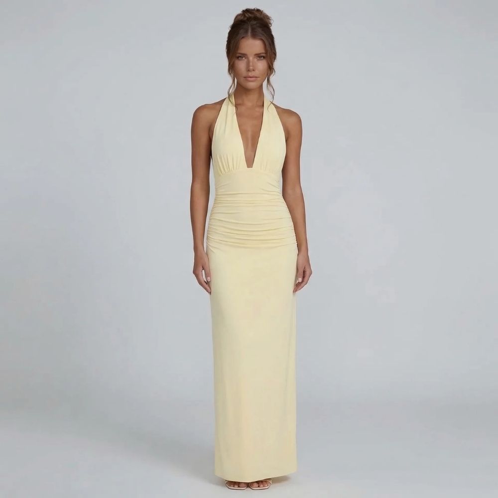 Yellow halter maxi dress — model styled for spring events with flowing skirt