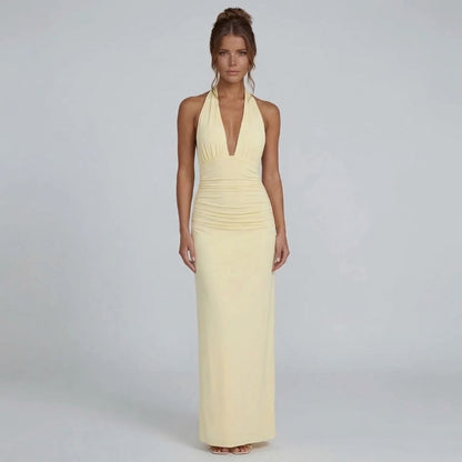 Yellow halter maxi dress — model styled for spring events with flowing skirt