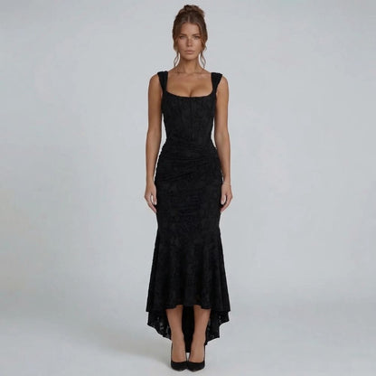 Black lace maxi dress with wide straps and high-low hem — front view styled with black pumps.