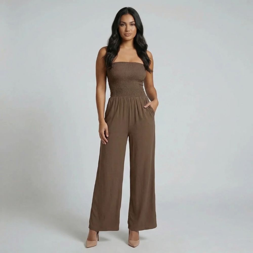 Brown smocked strapless jumpsuit with wide-leg silhouette — front view showing pockets.