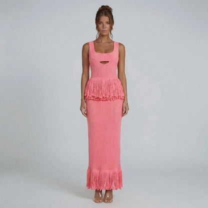 Pink ribbed-knit fringe maxi dress with square neckline — front view highlighting fringe detail at the waist and hem.