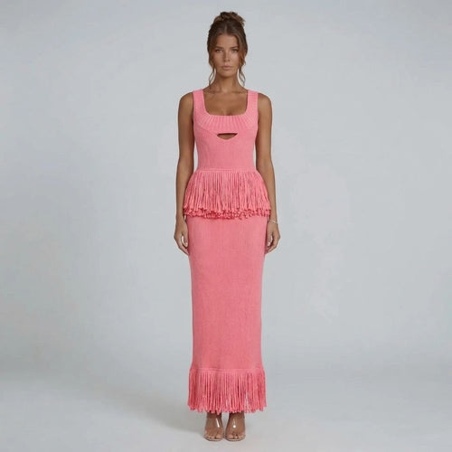 Pink ribbed-knit fringe maxi dress with square neckline — front view highlighting fringe detail at the waist and hem.