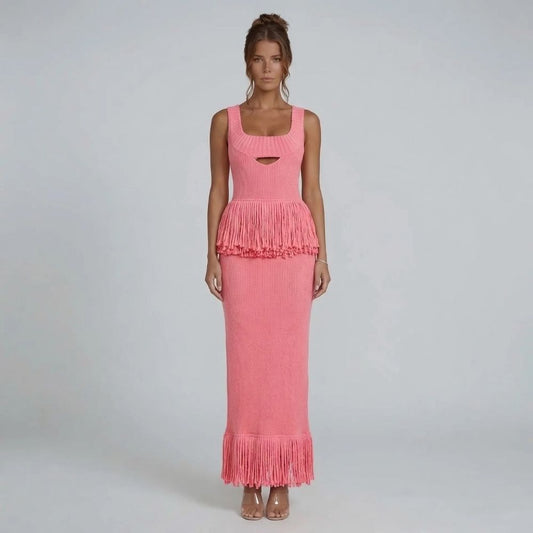 Pink ribbed-knit fringe maxi dress with square neckline — front view highlighting fringe detail at the waist and hem.