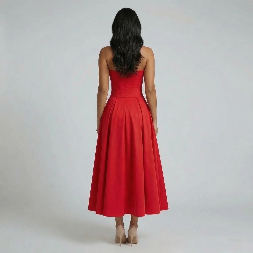 Red corset midi dress — back view showing fitted waist and flowing A-line skirt.