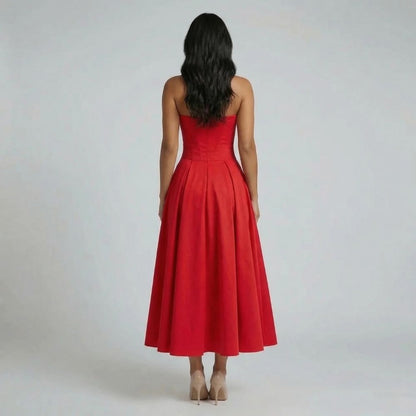 Red corset midi dress — back view showing fitted waist and flowing A-line skirt.