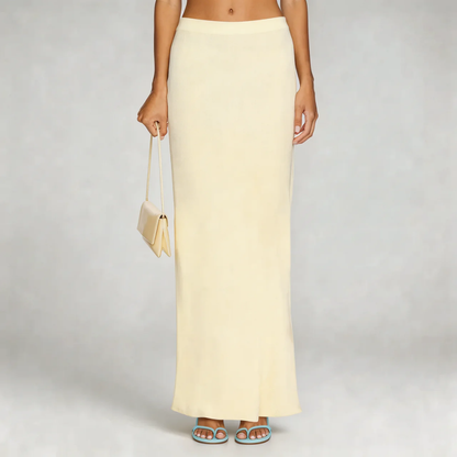 Beige high-waist maxi skirt—side view highlighting streamlined design and smooth finish.