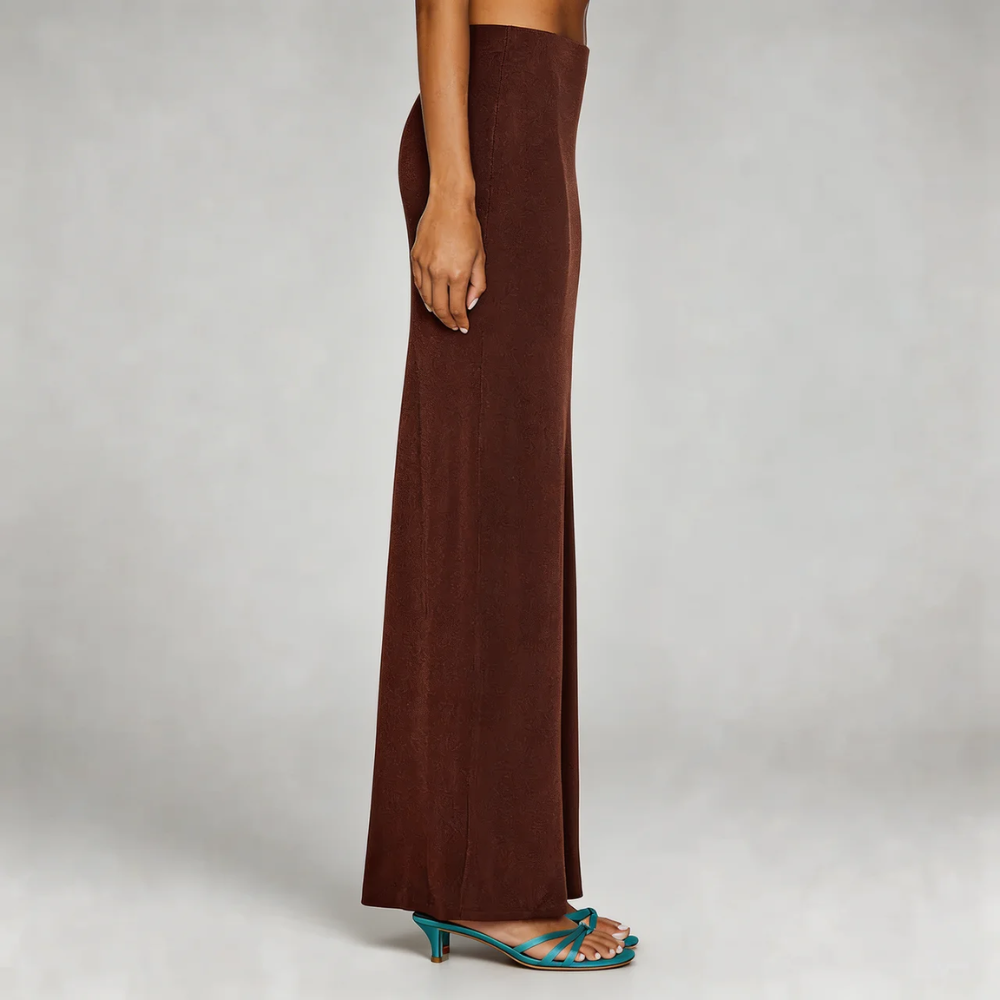 Burgundy high-waist maxi skirt—side profile showcasing elongating column shape and comfortable stretch fabric.