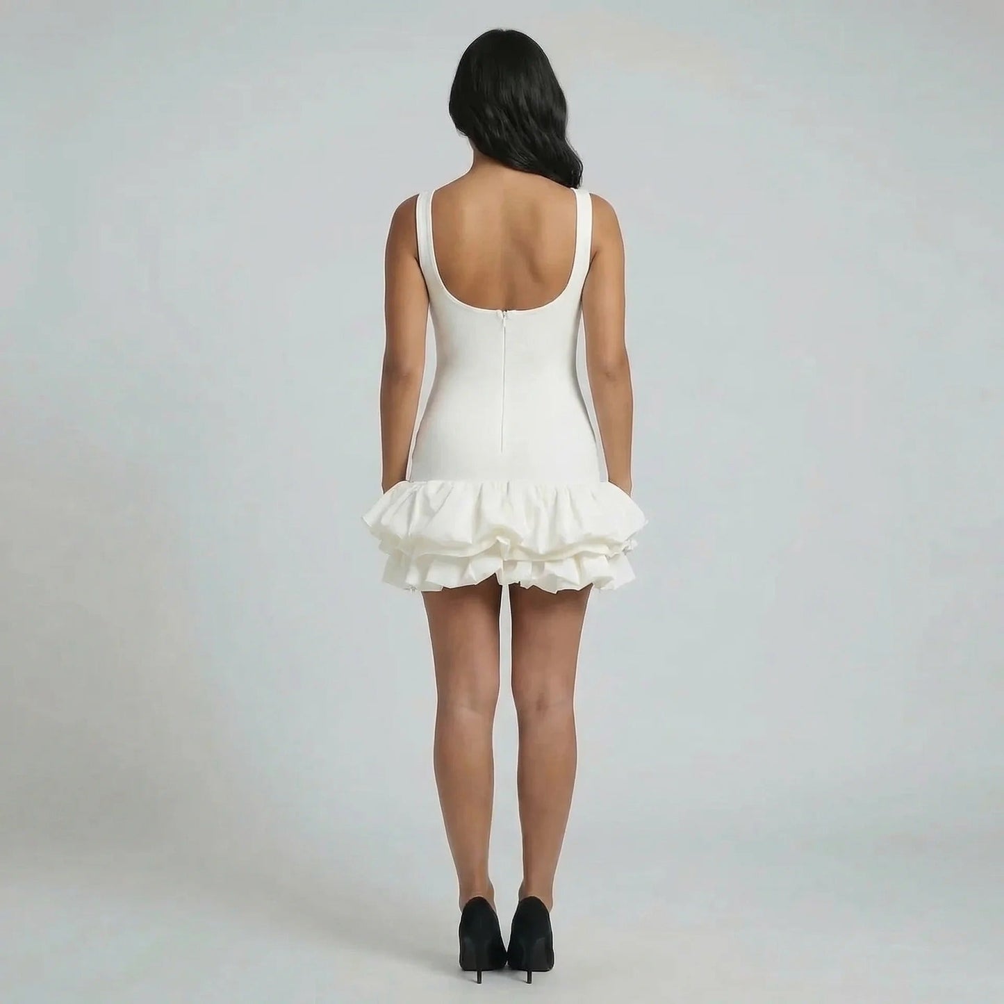 White ruffle mini dress with sculpted fit and zip-back detail — back view.