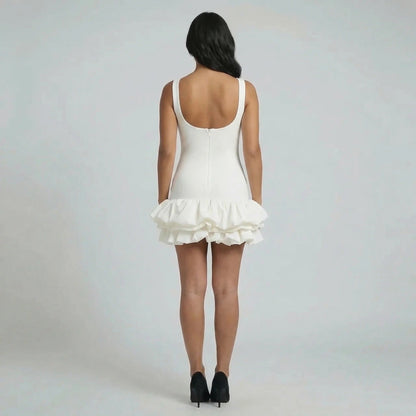 White ruffle mini dress with sculpted fit and zip-back detail — back view.