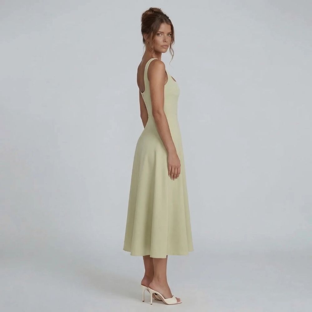 Sage A-line midi dress — side view featuring wide supportive straps and smooth skirt.