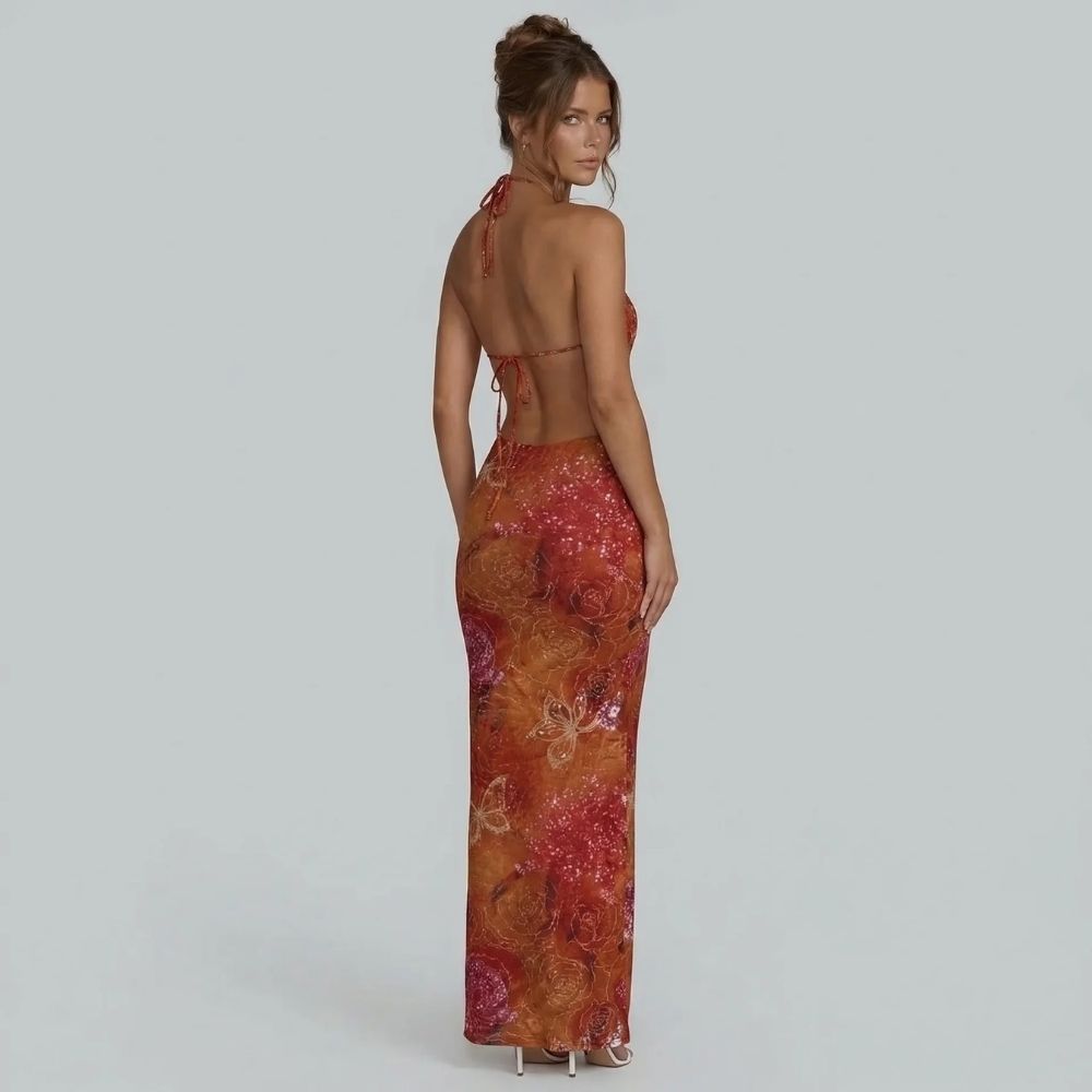Red floral halter maxi dress with open back tie — back view highlighting adjustable ties and waist cutouts.