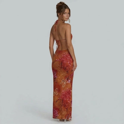 Red floral halter maxi dress with open back tie — back view highlighting adjustable ties and waist cutouts.