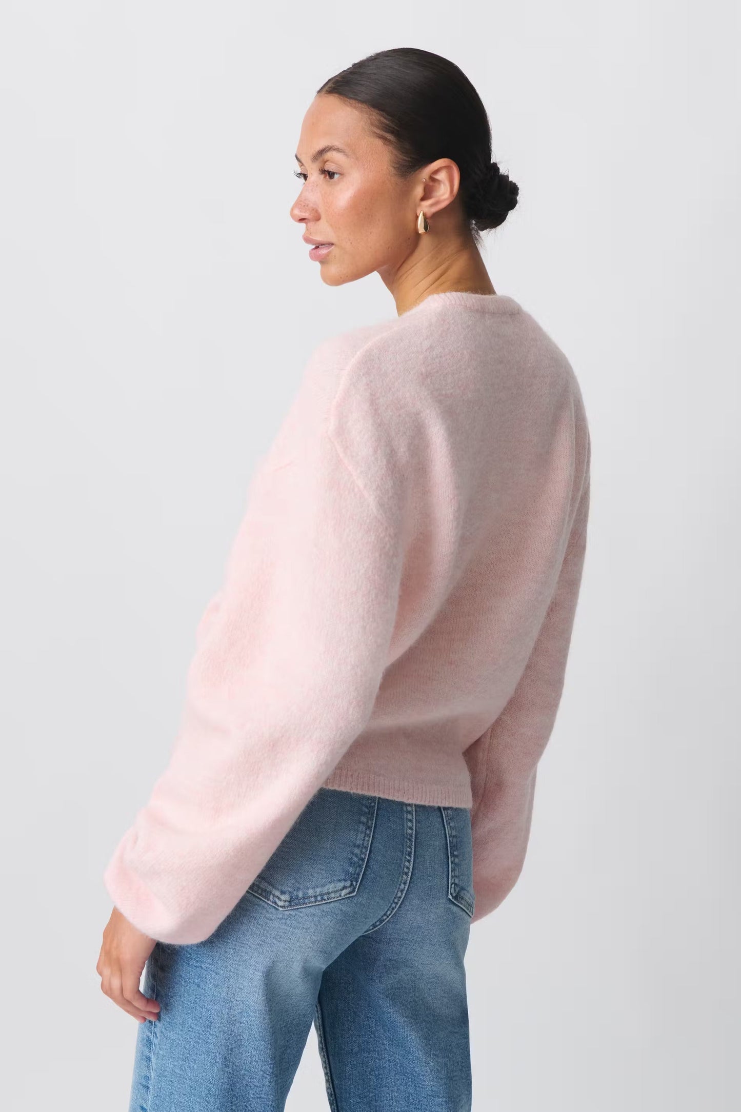 Women crew neck button solid cardigan, back view