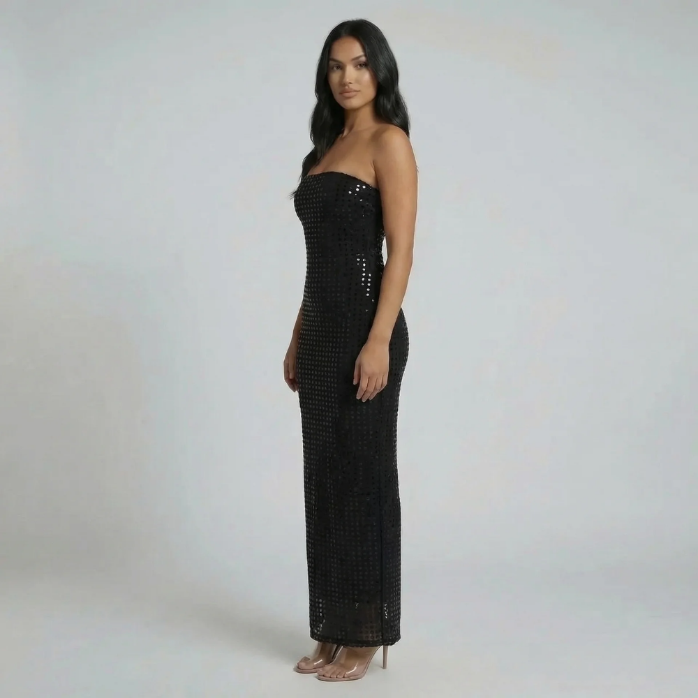 Black sequin strapless maxi dress — side view showing body-hugging silhouette and shimmering finish