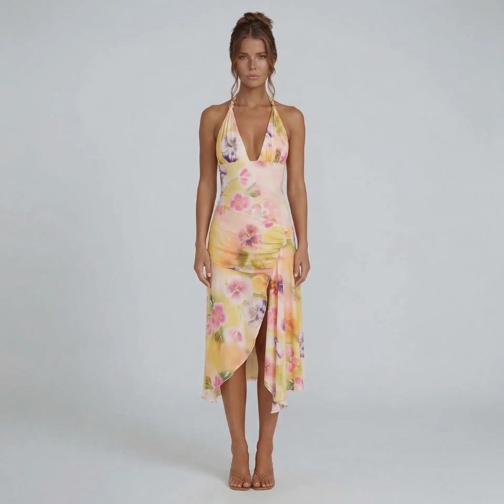 Cream floral halter midi dress with asymmetrical wrap skirt — front view displaying ruched hip detail and vibrant print.