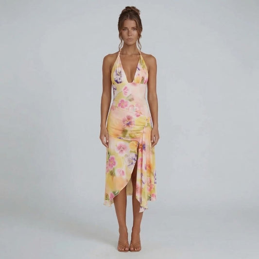 Cream floral halter midi dress with asymmetrical wrap skirt — front view displaying ruched hip detail and vibrant print.
