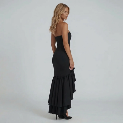 Black strapless ruffle maxi dress — back view showcasing fitted silhouette and layered hem.