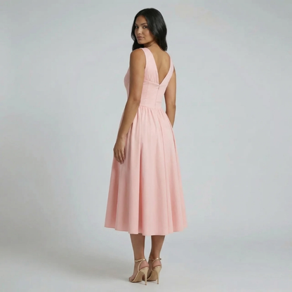 Pink A-line midi dress with corset seams — back view showcasing fitted bodice.