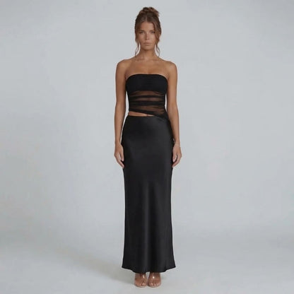 Black strapless ruched maxi dress with side cutout — front view showcasing modern silhouette and sleek details.