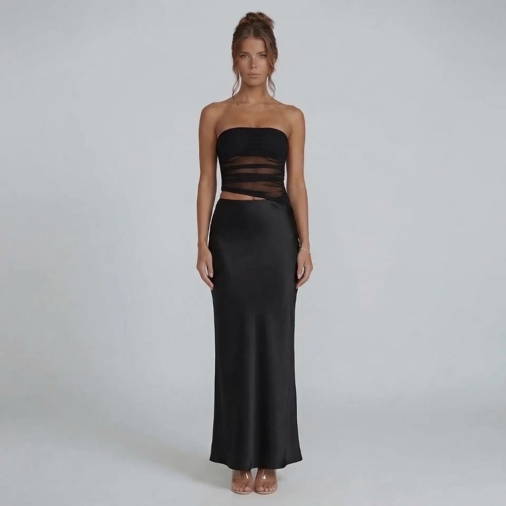 Black strapless ruched maxi dress with side cutout — front view showcasing modern silhouette and sleek details.