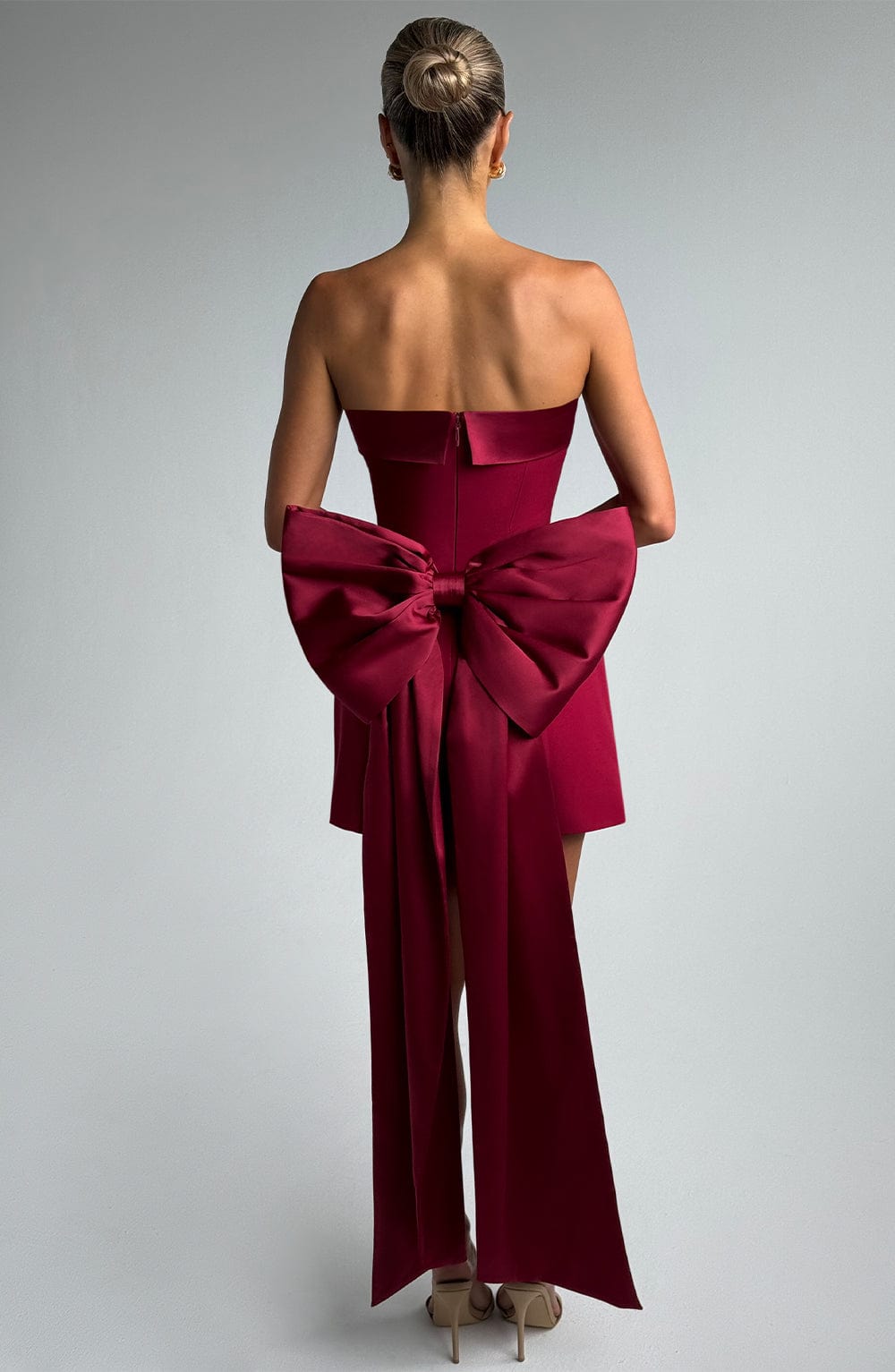 Women wine strapless mini dress, side view
