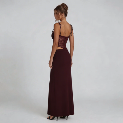 Burgundy maxi dress showcasing flowing maxi skirt and lace-up back — side angle