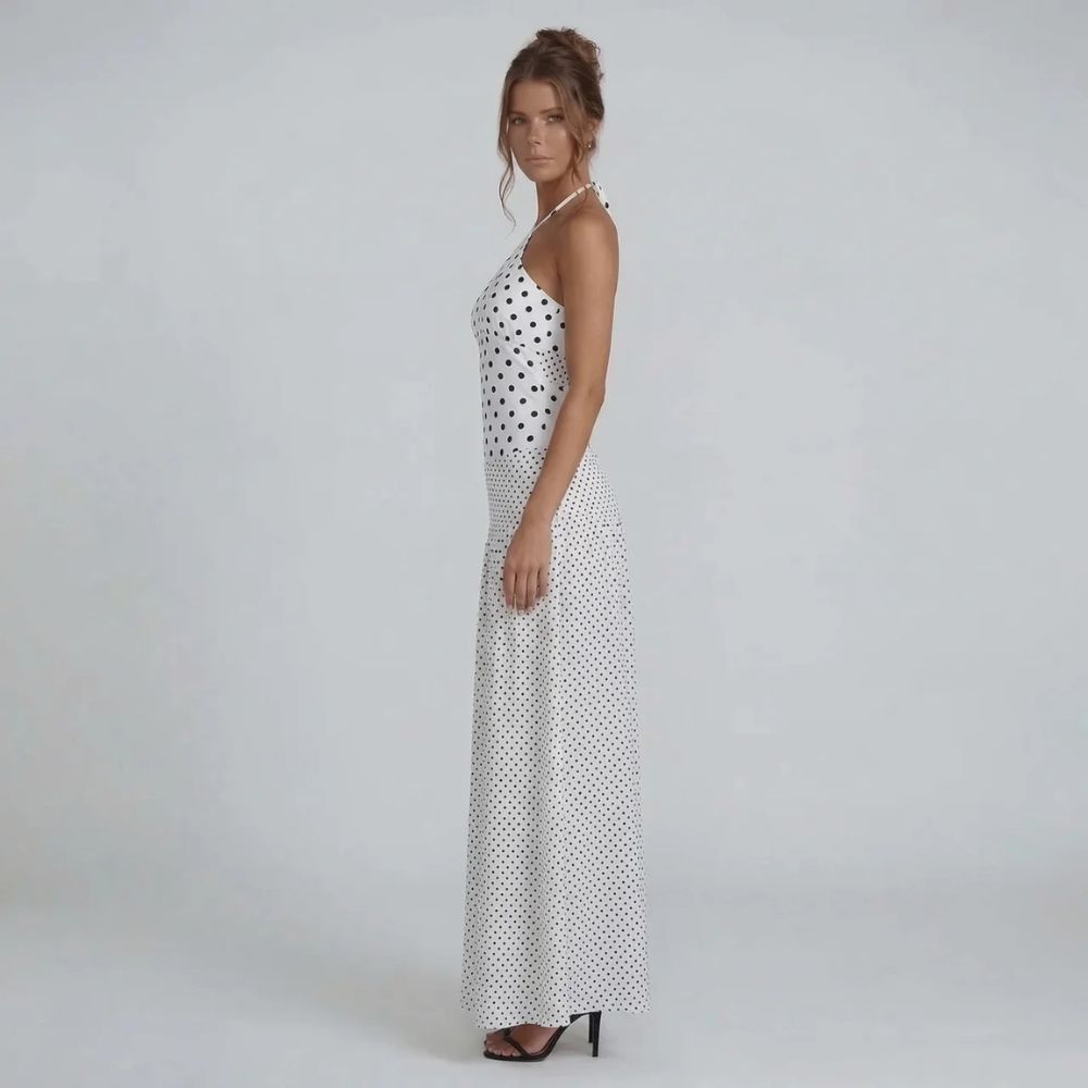 White polka dot maxi dress — side view highlighting adjustable halter straps and flattering fitted bodice.