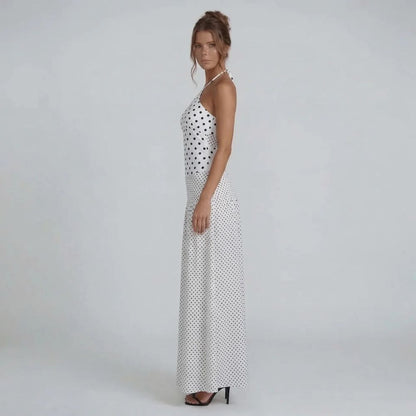 White polka dot maxi dress — side view highlighting adjustable halter straps and flattering fitted bodice.