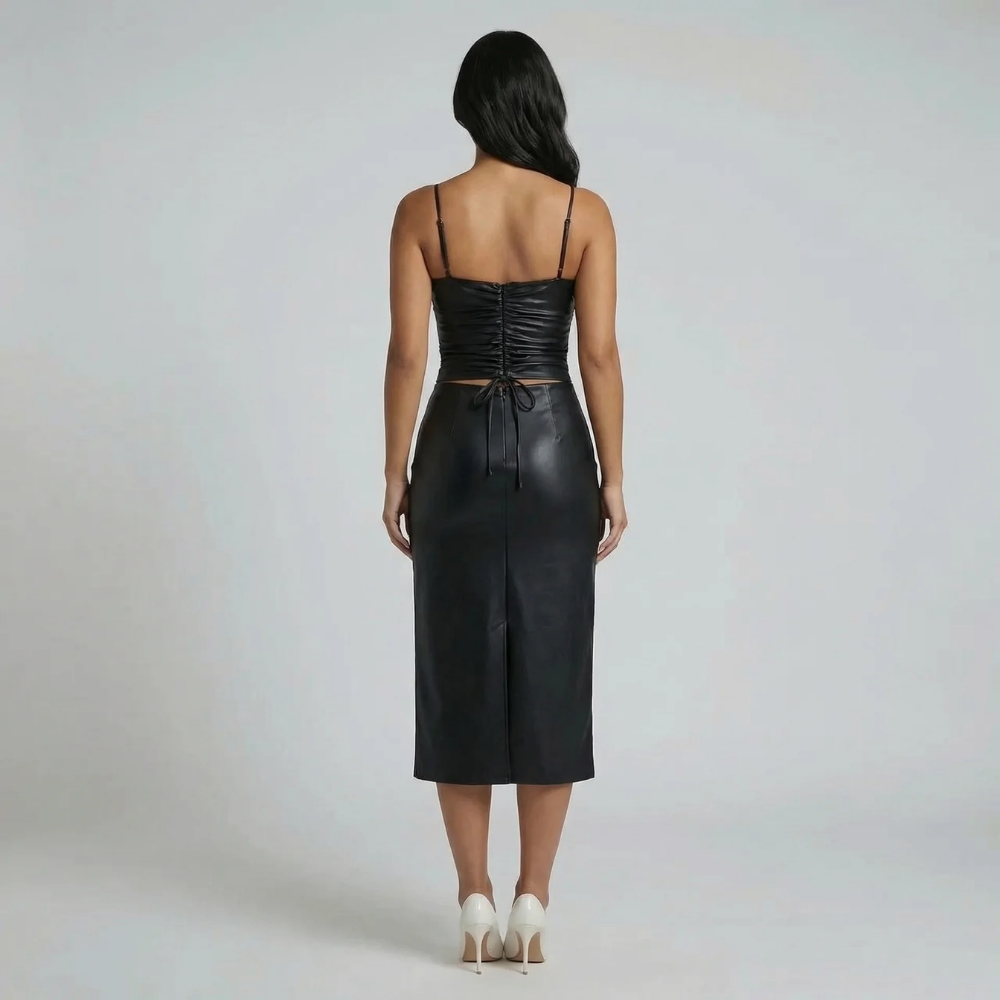 Black vegan leather midi dress — back view featuring corset details and hem slit.