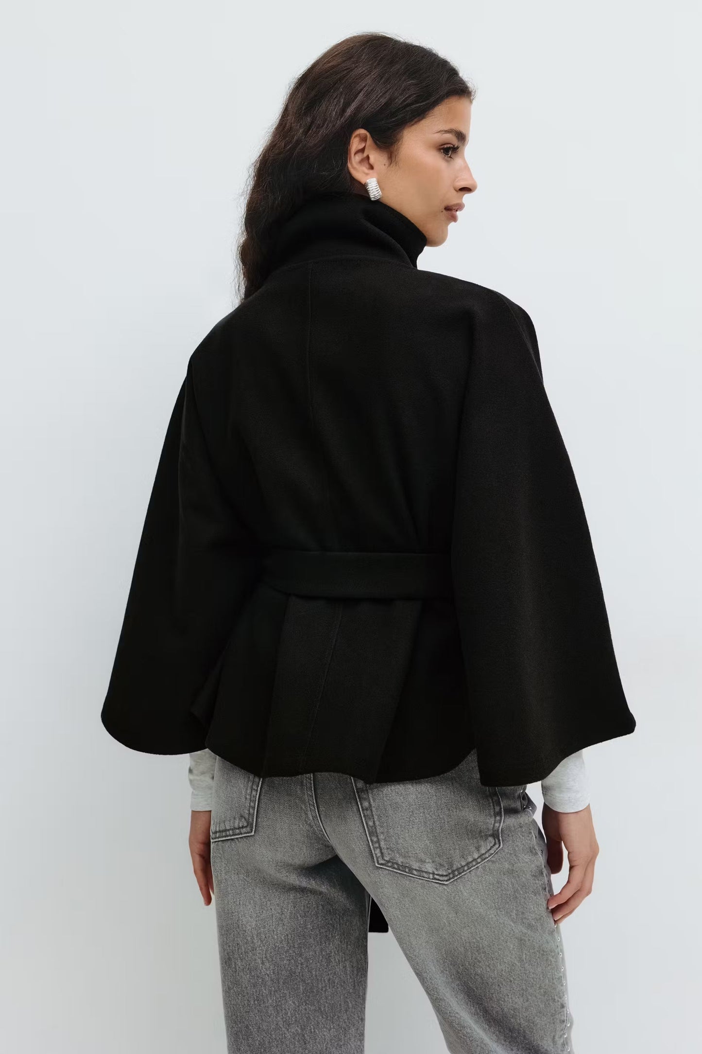 Women black funnel neck draped coat, back view