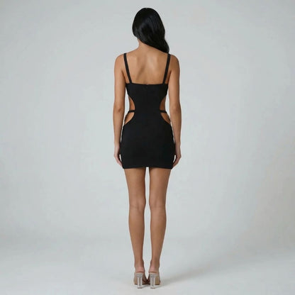 Black cutout bodycon mini dress — back view showcasing zipper closure and cutout details.